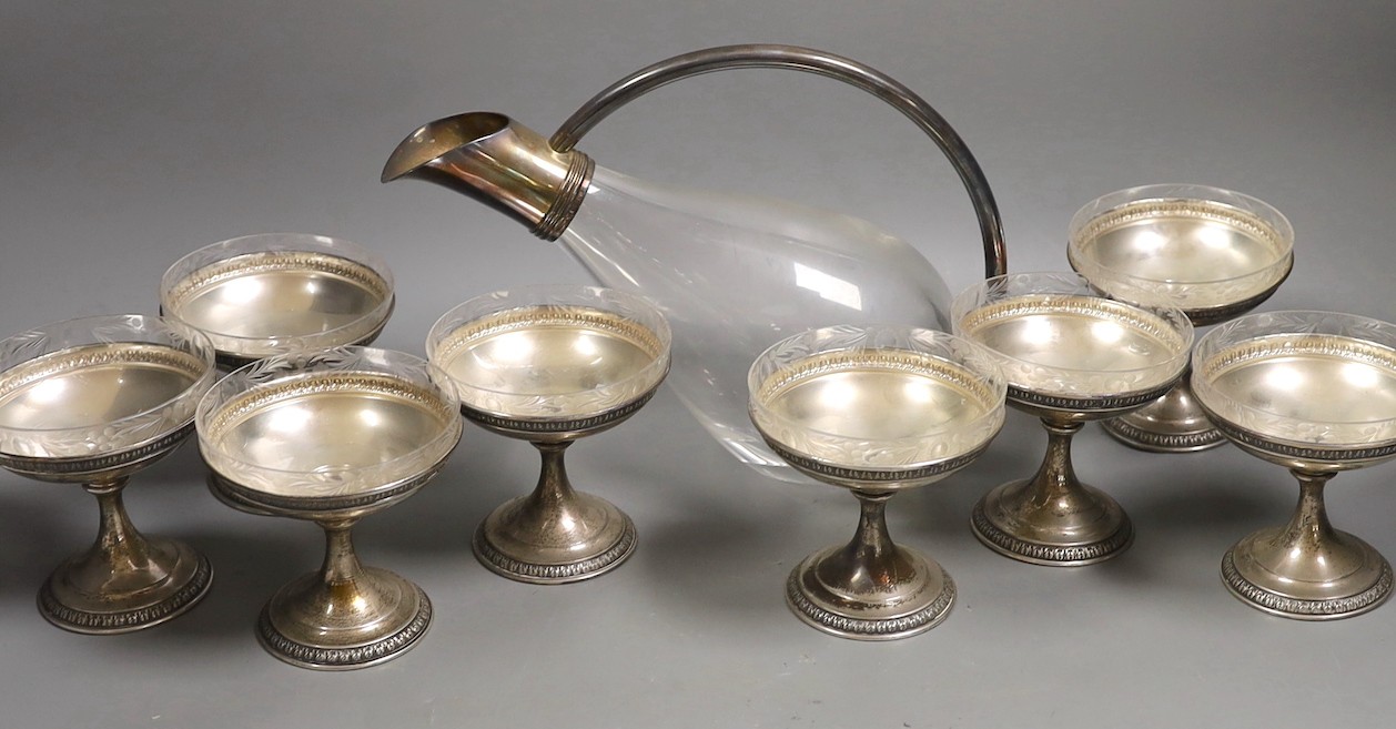 A set of eight sterling dessert coupes with glass inserts, height 6mm, together with a modern silver mounted decanter, by Asprey & Co Ltd (lacking stopper - one glass insert missing)